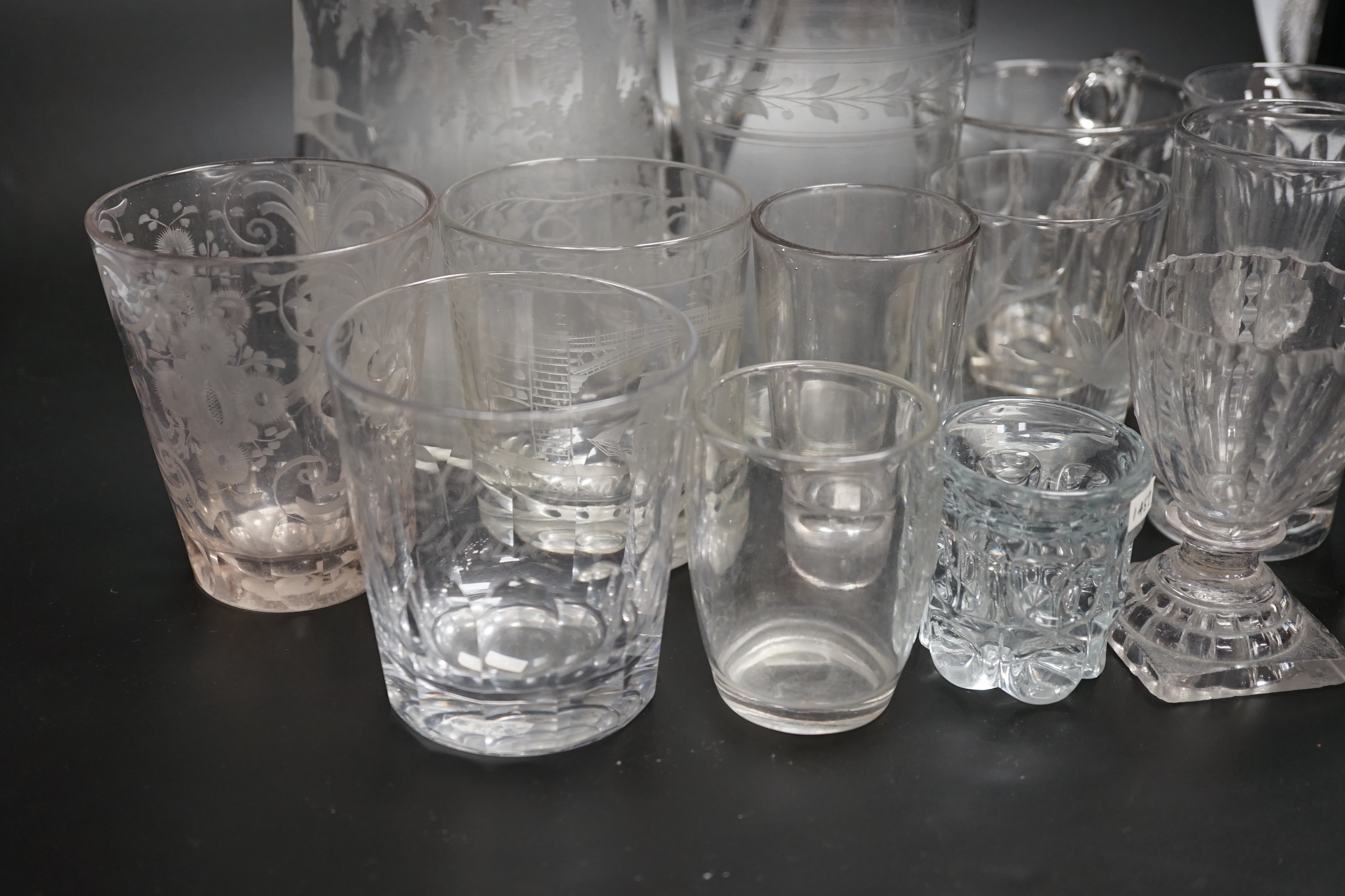 Fourteen 19th century glass items, including a jug heavily engraved with a scene of a stag in a woodland glade, an engraved Sunderland Bridge tumbler, together with another three engraved tumblers, plus some smaller brea